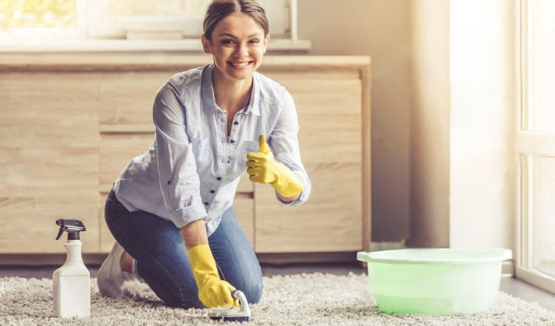 pretty young woman scrubbing the floor